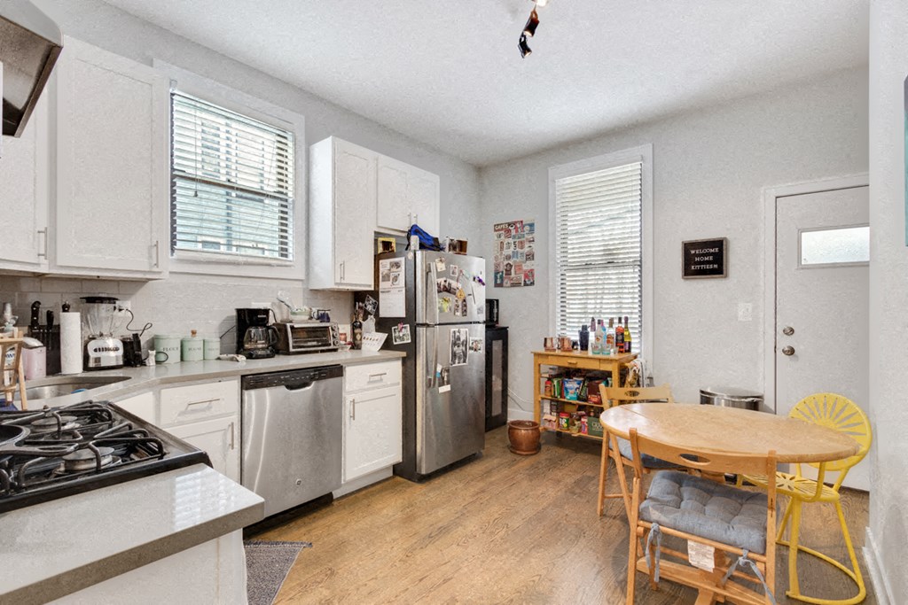 a kitchen with a table and a refrigerator