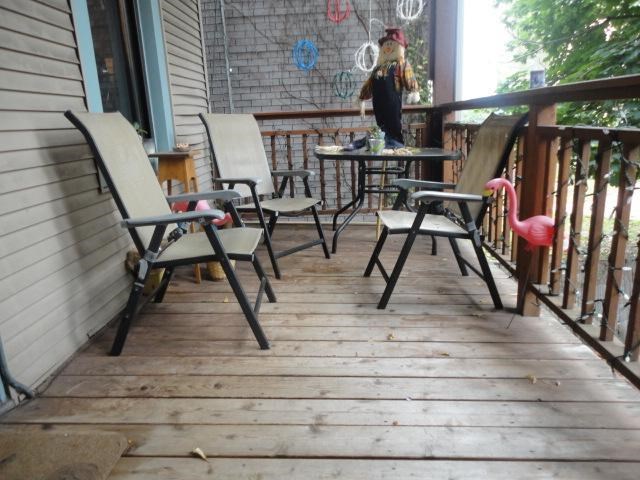 a patio with chairs and tables on a porch