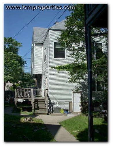 a white house with a porch and stairs
