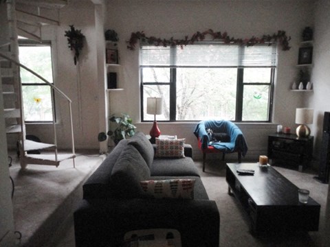 a living room filled with furniture and a large window