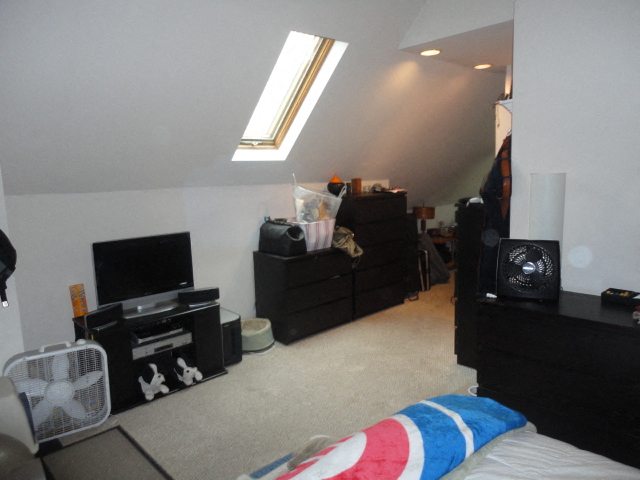 a room with a bed and a tv in it