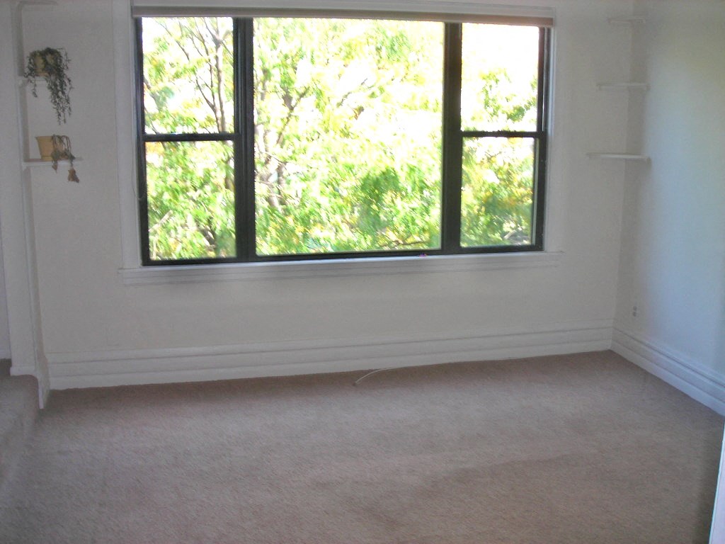 an empty living room with a large window