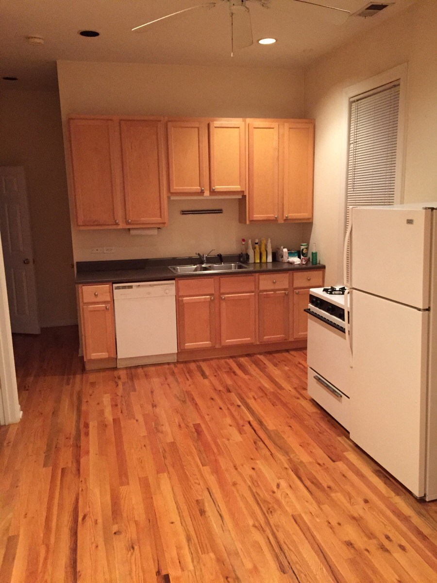 a kitchen with wooden floors and white appliances