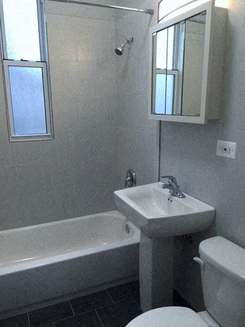 a bathroom with a sink toilet and a bath tub