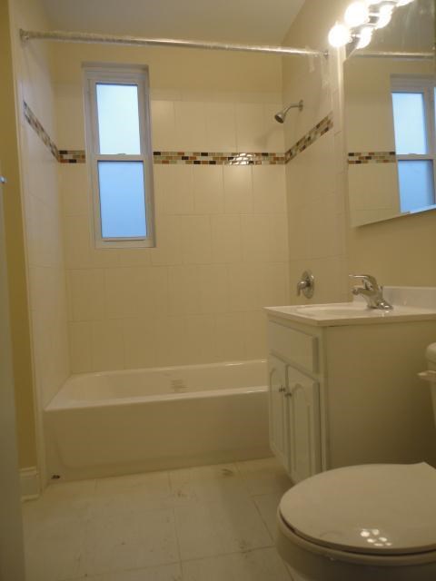 a bathroom with a toilet and a tub and a sink