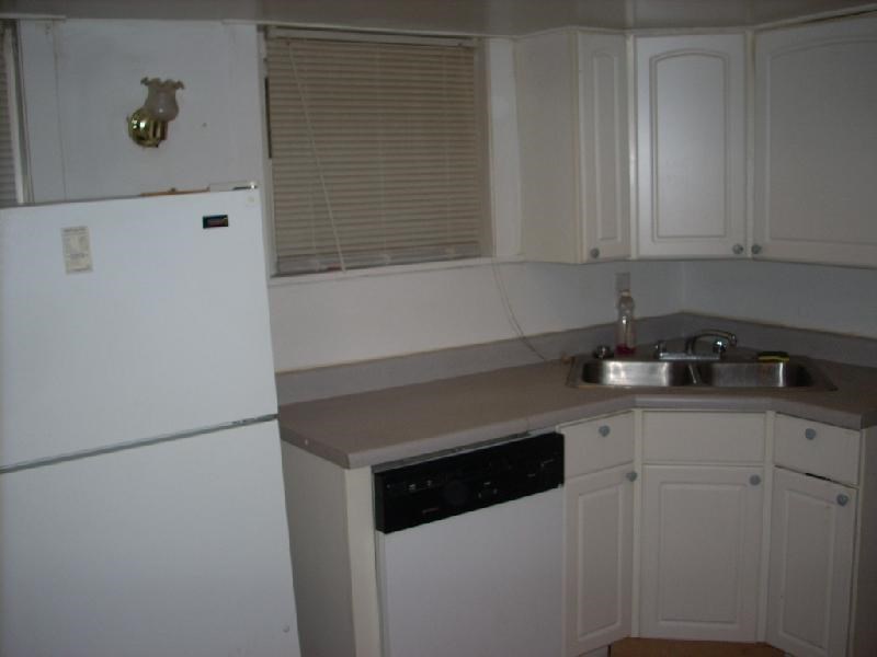 a kitchen with a sink and a refrigerator