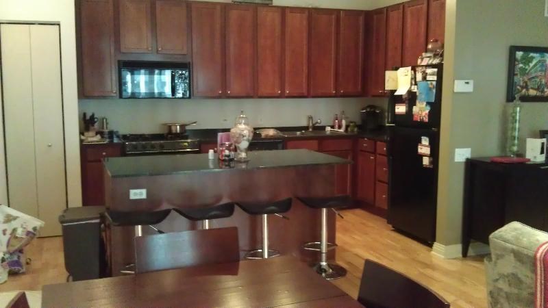a kitchen with a bar and a dining table