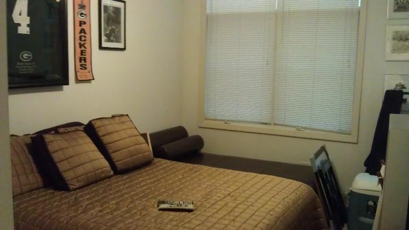 a bedroom with a bed and a window