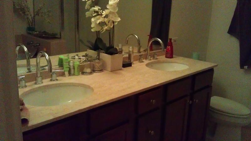 a bathroom with two sinks and a toilet and a mirror