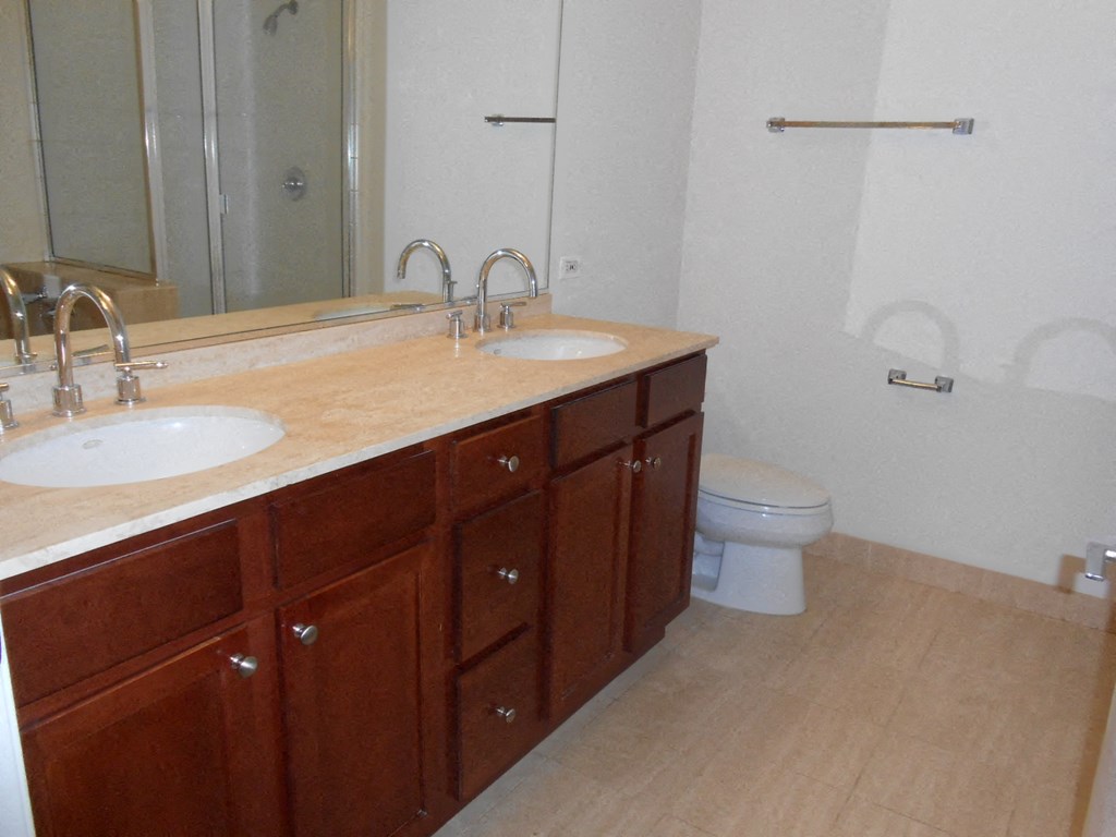 a bathroom with two sinks and a toilet