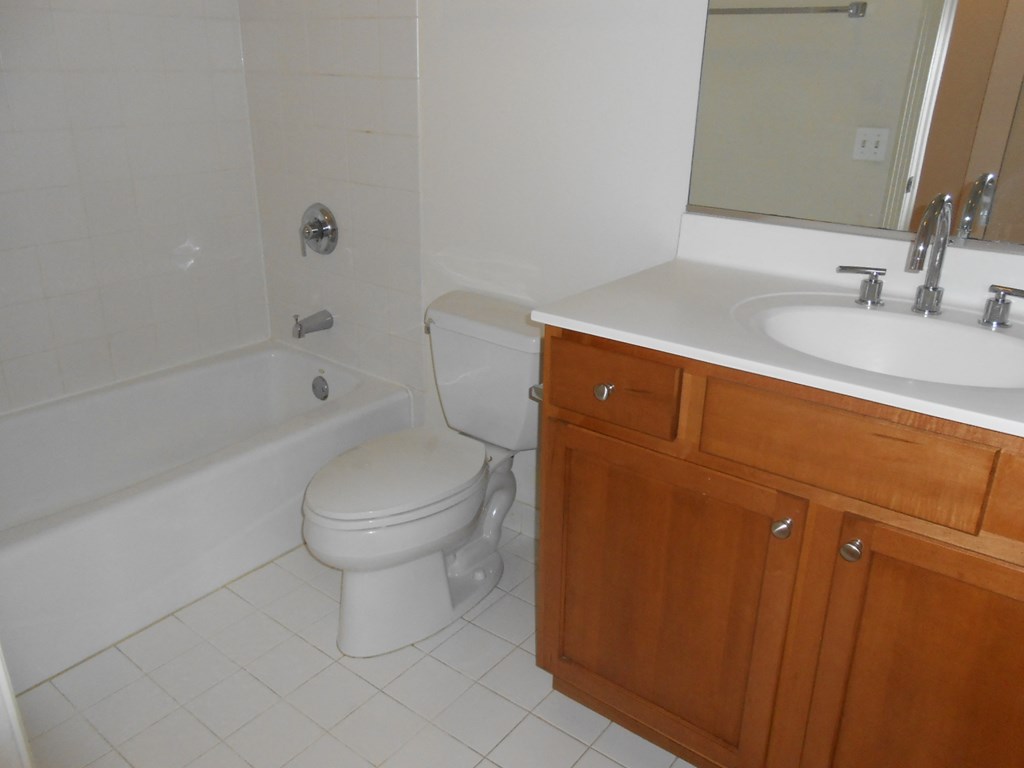 a bathroom with a sink toilet and bath tub