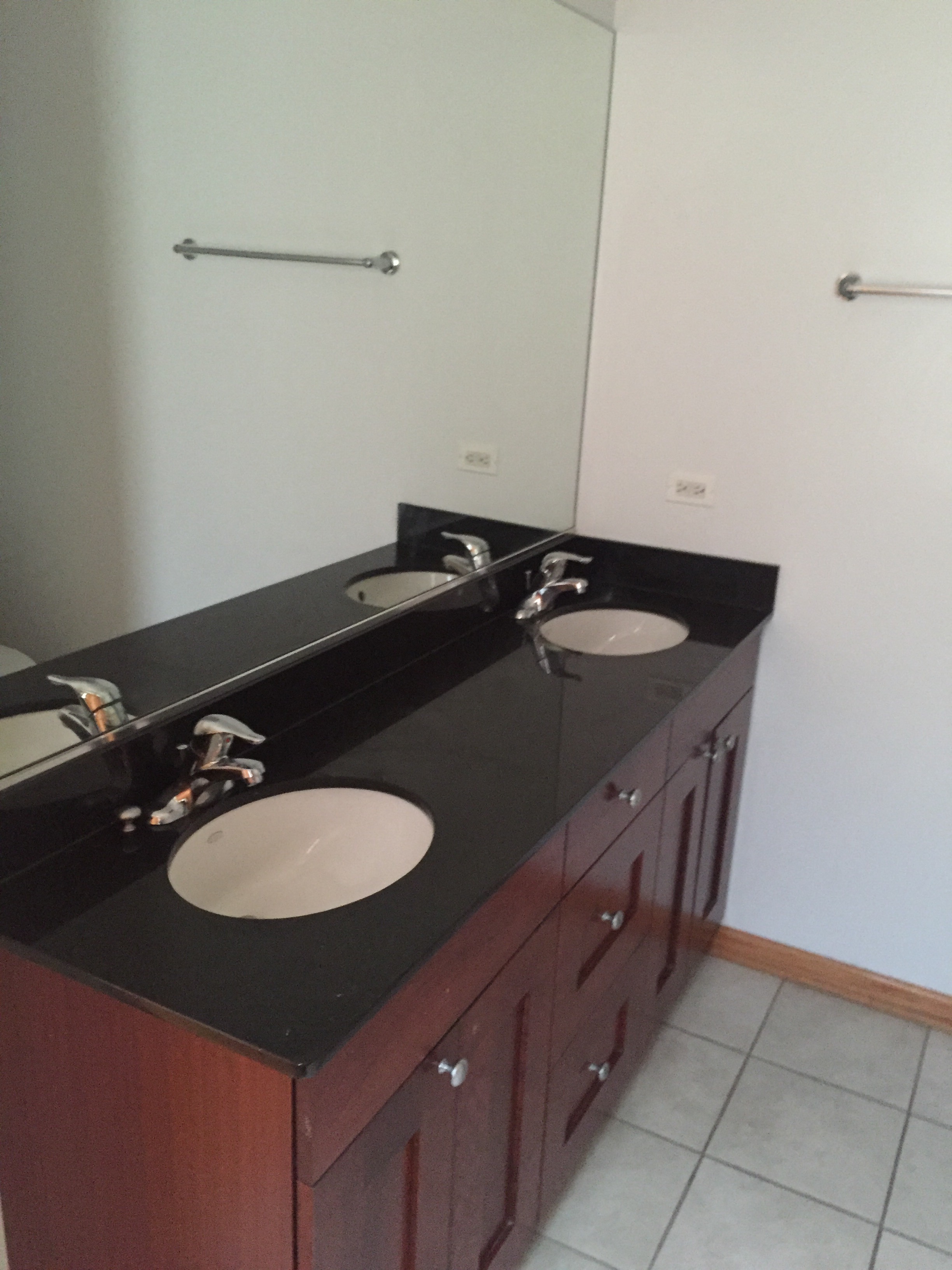 a bathroom with two sinks and a mirror