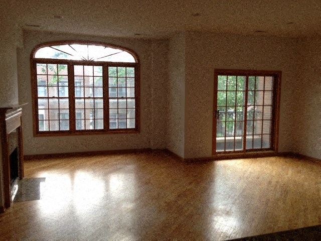 an empty living room with a large window