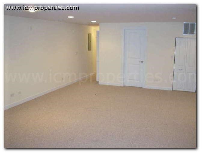 an empty living room with a white door
