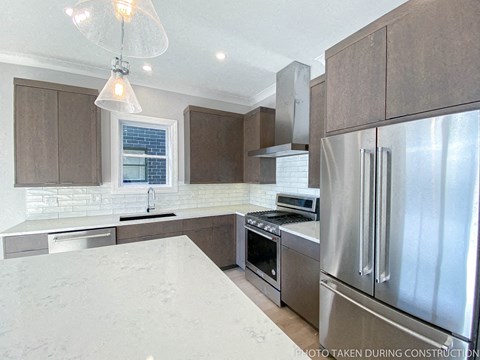 a kitchen with stainless steel appliances and white counter tops