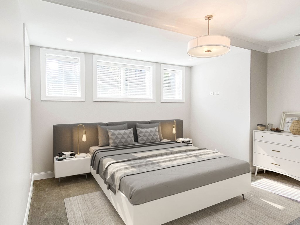 a bedroom with a bed and three windows