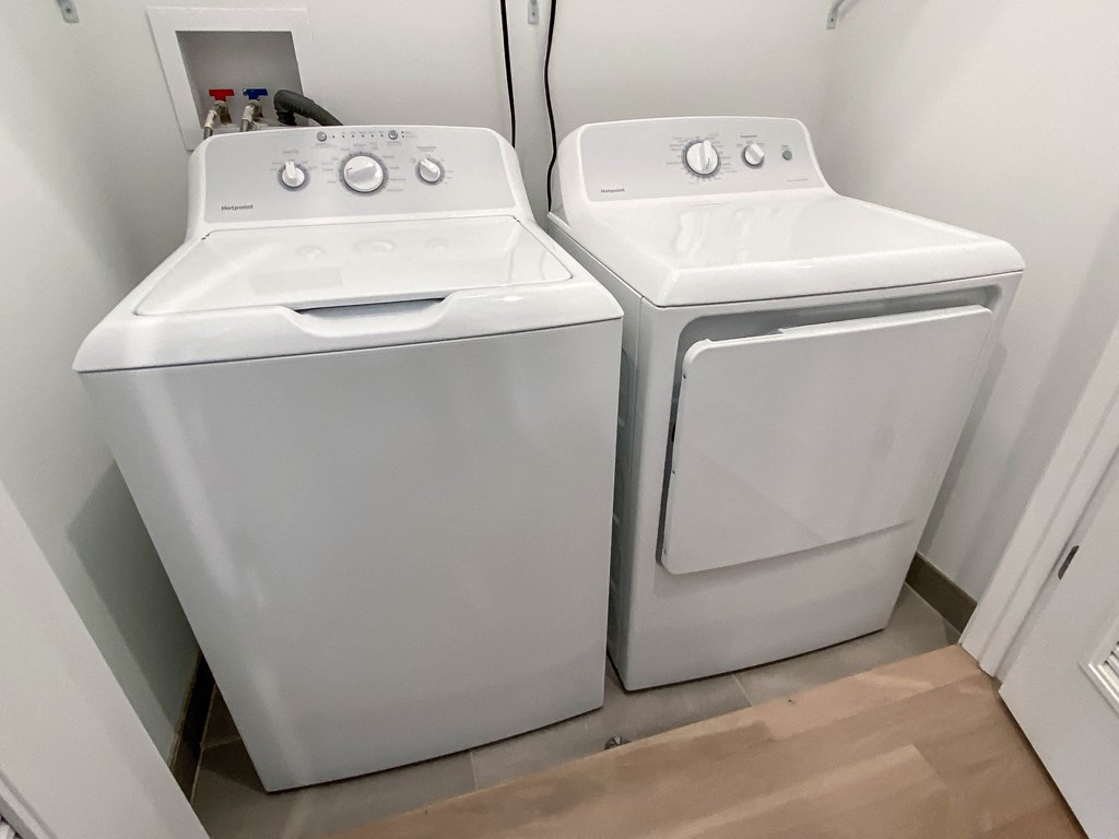 two white washers and dryers in a white room