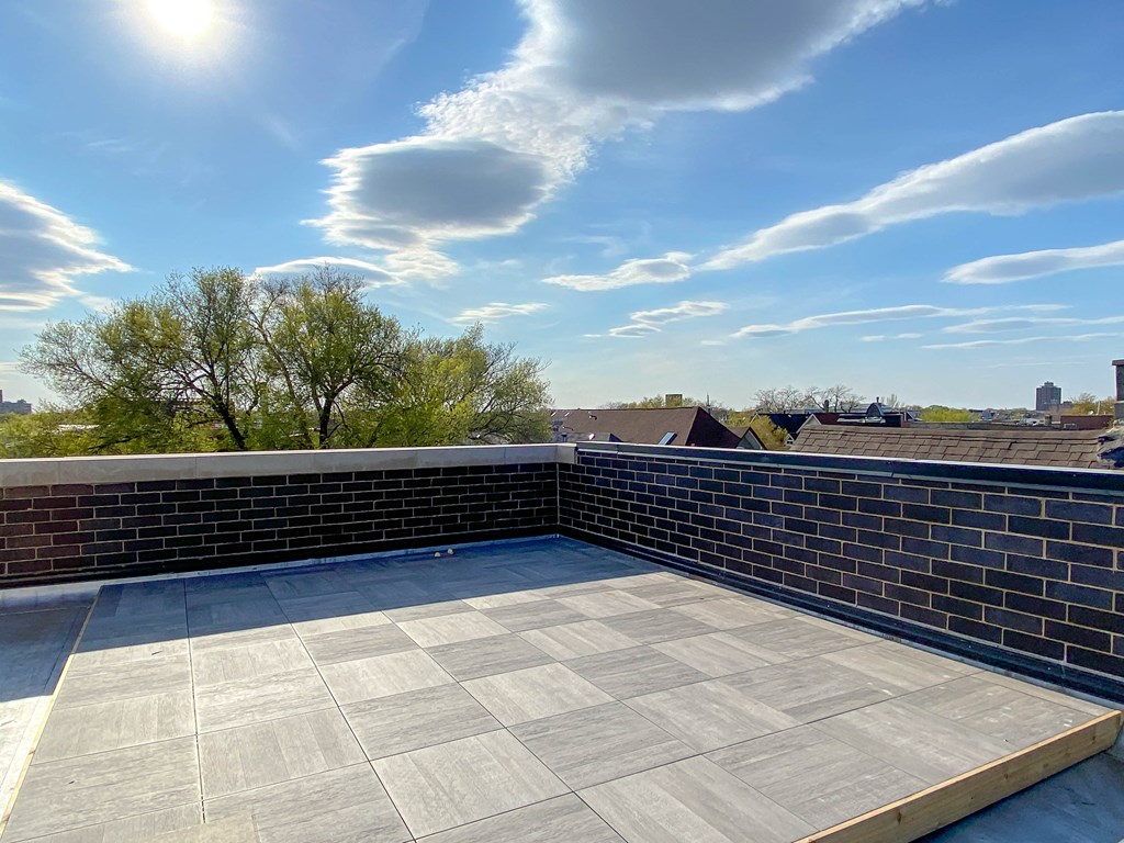 the roof of a building with a blue sky in the background