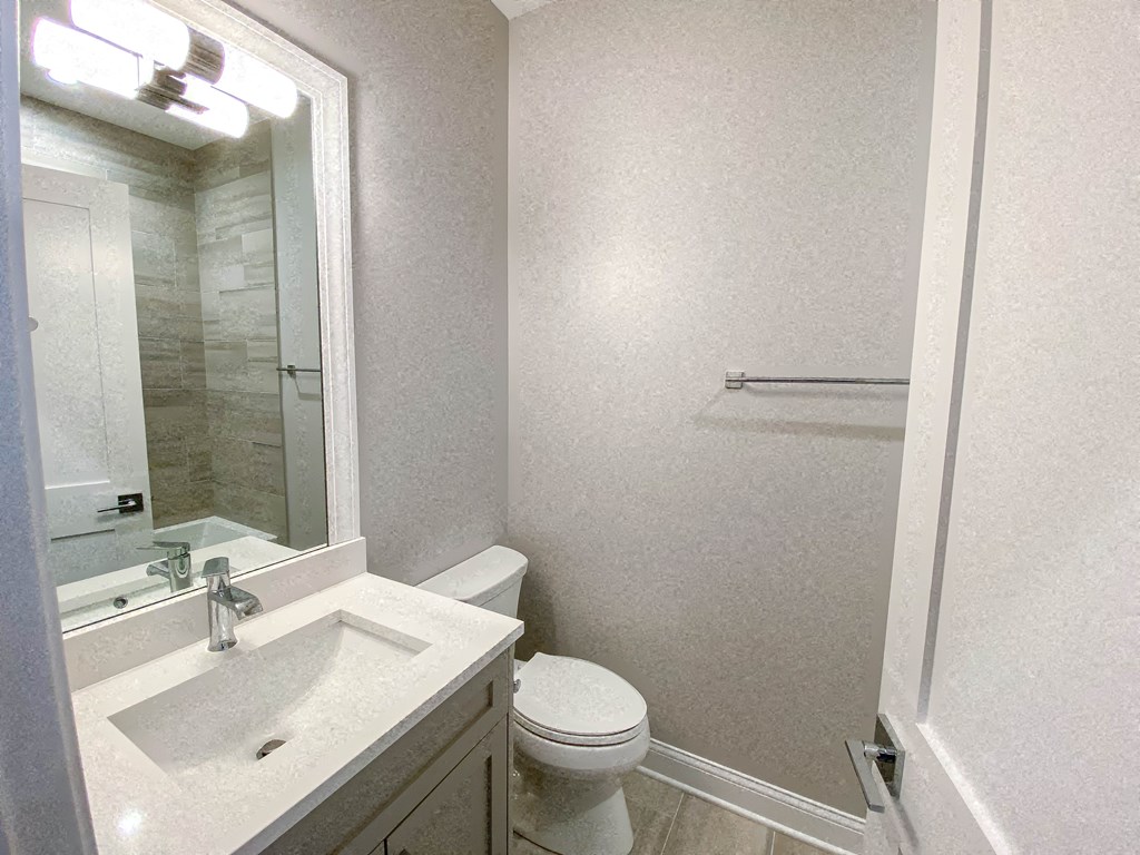a bathroom with a sink toilet and a mirror