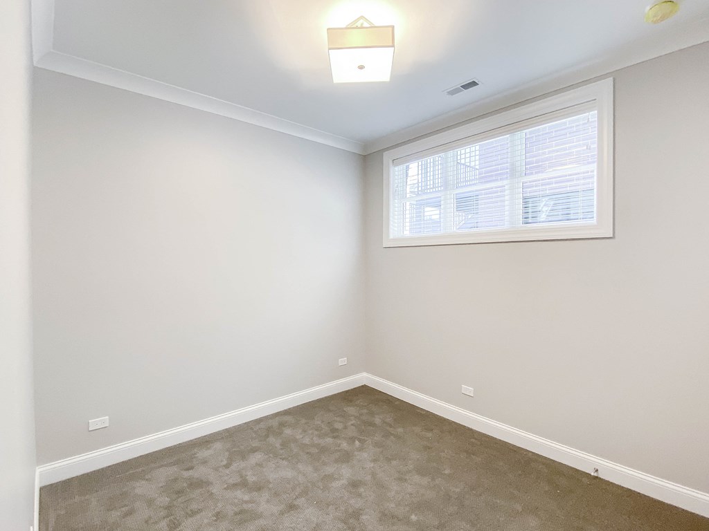 an empty room with white walls and a window