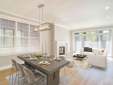 a dining room and living room with a table and chairs