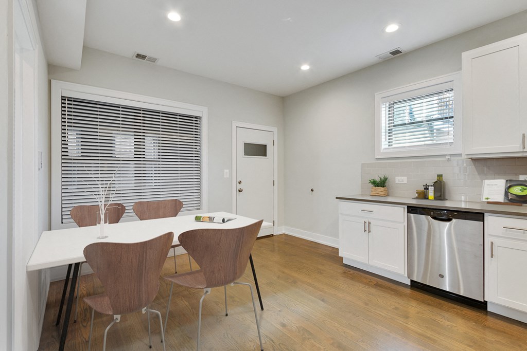 an open kitchen and dining room with a table and chairs