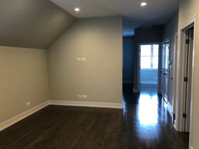 a empty room with wood floors and a door