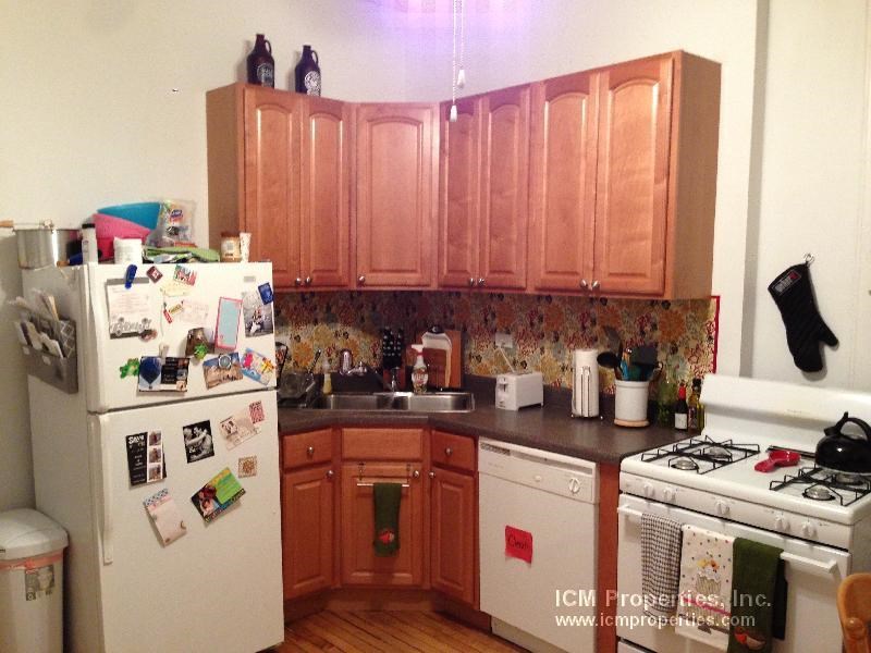 a kitchen with a stove and a refrigerator