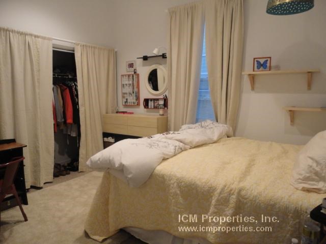 a bedroom with a bed and a closet