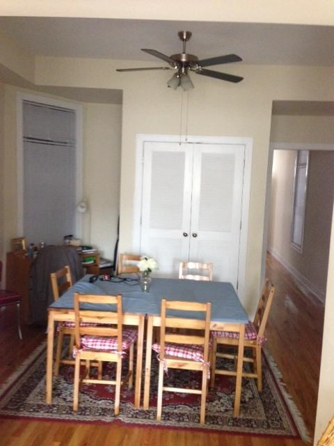 a dining room table with chairs and a ceiling fan