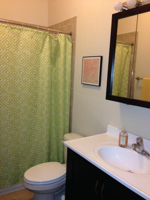 a bathroom with a toilet and a sink and a shower