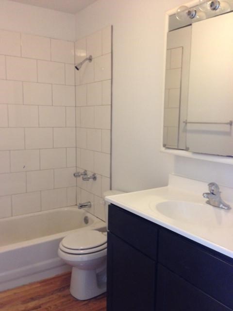 a bathroom with a toilet and a sink and a tub