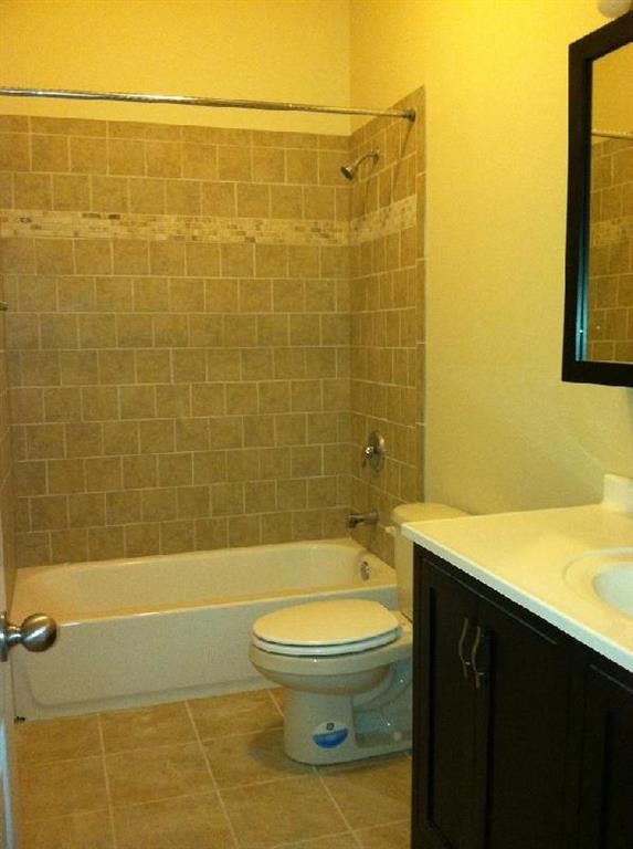 a bathroom with a toilet and a tub and a sink