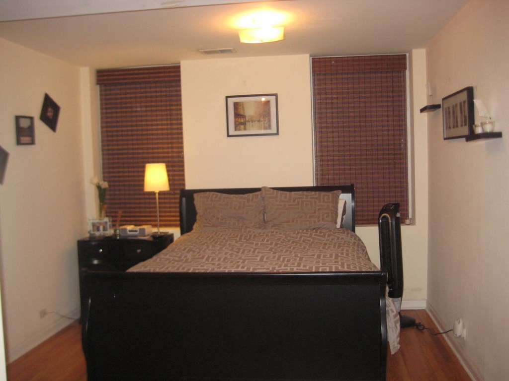 a bedroom with a large bed and a window