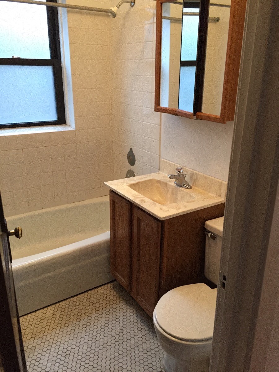 a bathroom with a toilet and a sink and a bath tub