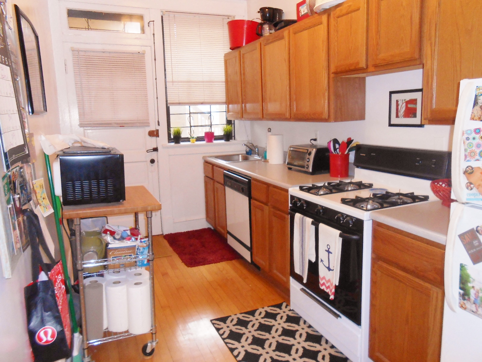 a kitchen with wooden cabinets and a stove and a refrigerator