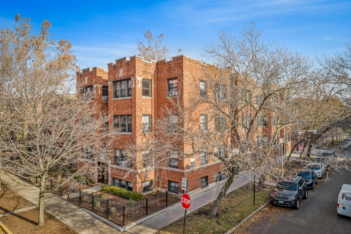 a red brick building with cars parked in front of it