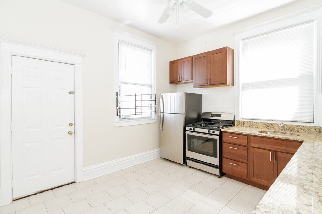 a kitchen with a stove and a refrigerator and a sink