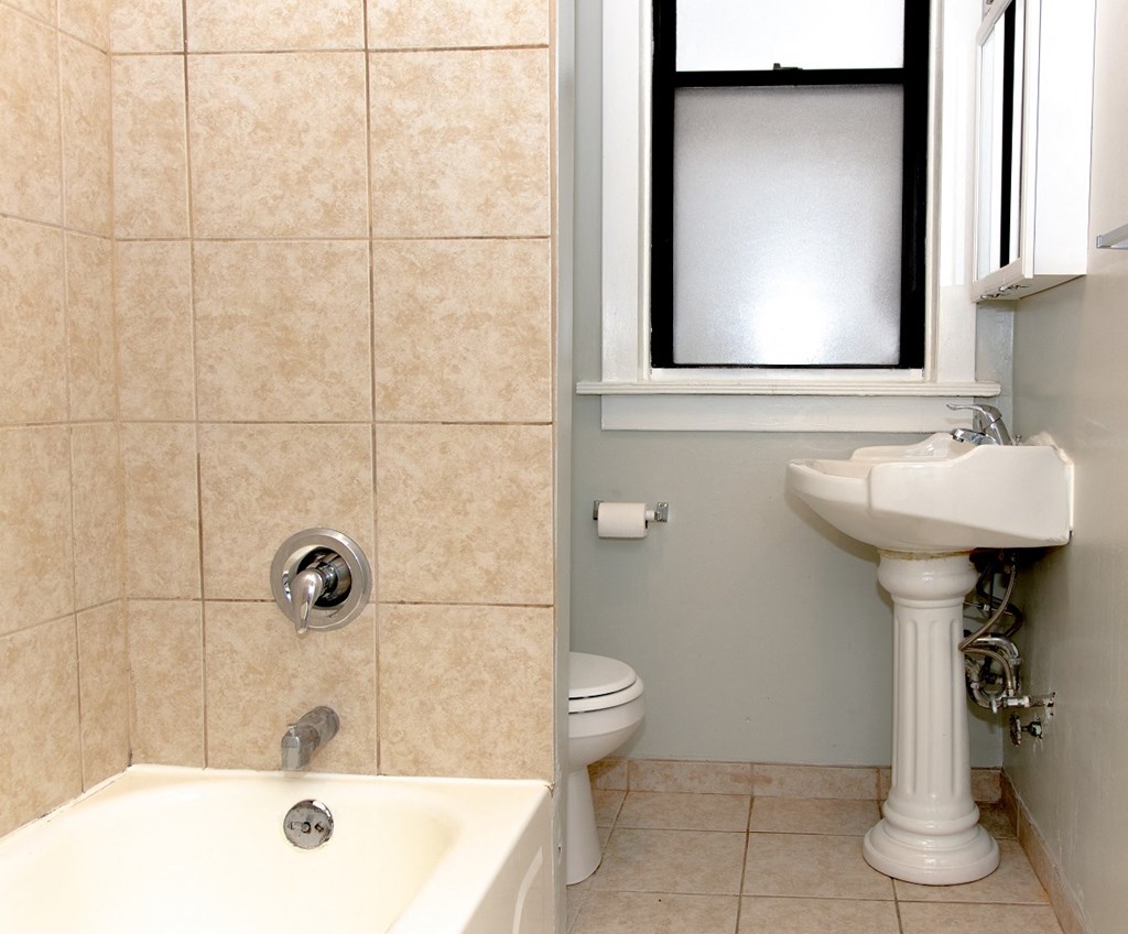 a bathroom with a sink toilet and a window