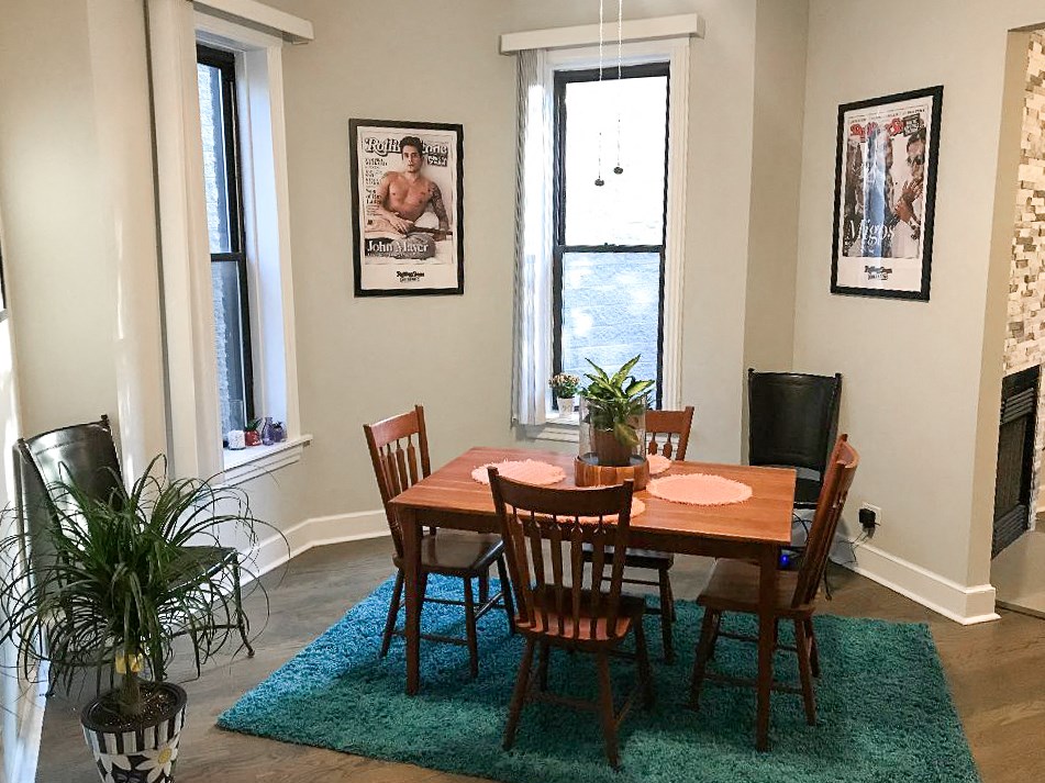 a dining room with a wooden table and chairs