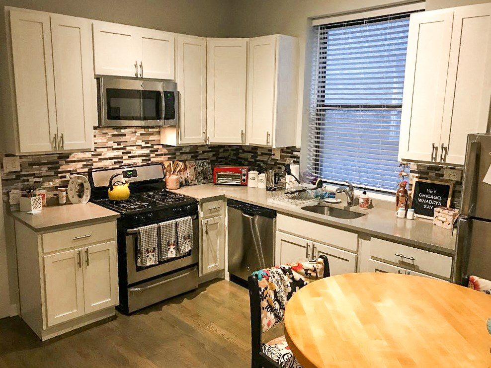 a kitchen with a wooden table and a stove top oven