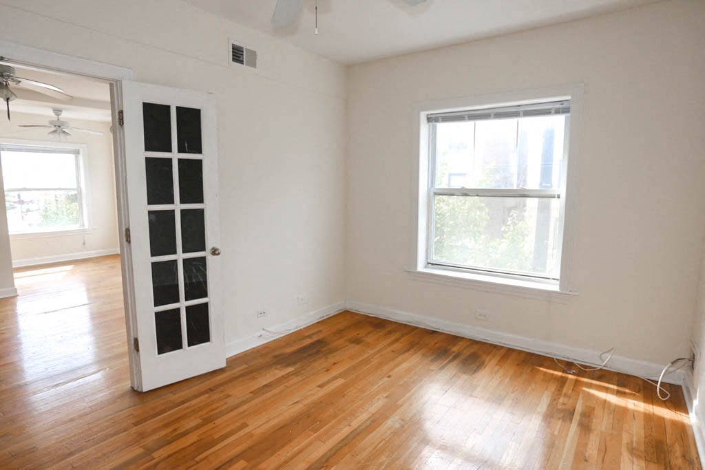 an empty room with a door and a window