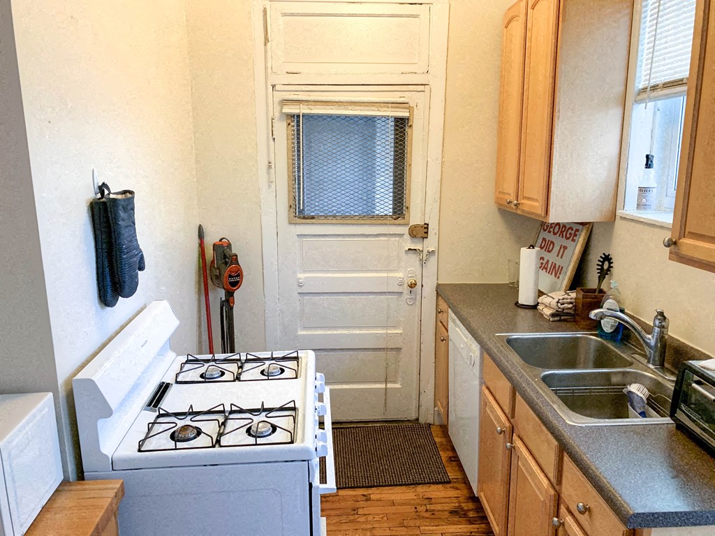 a small kitchen with a stove and a sink