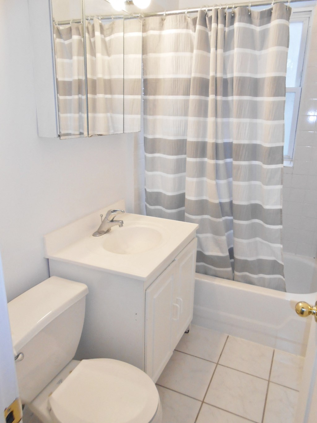 a small bathroom with a sink toilet and shower