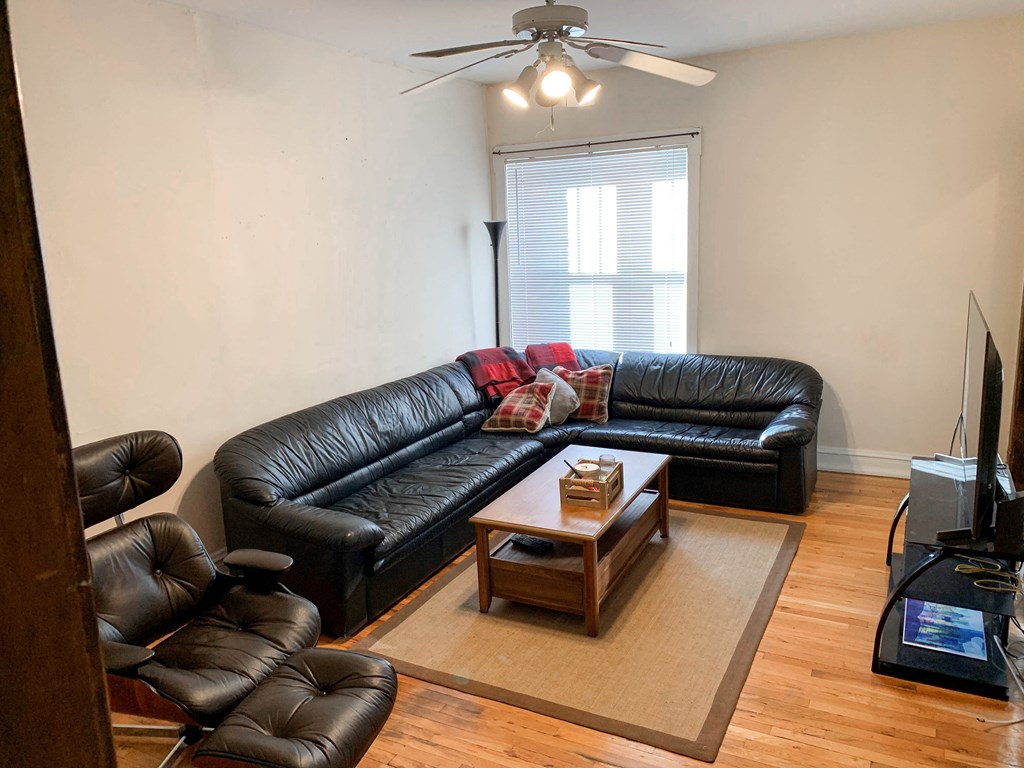a living room with leather couches and a coffee table