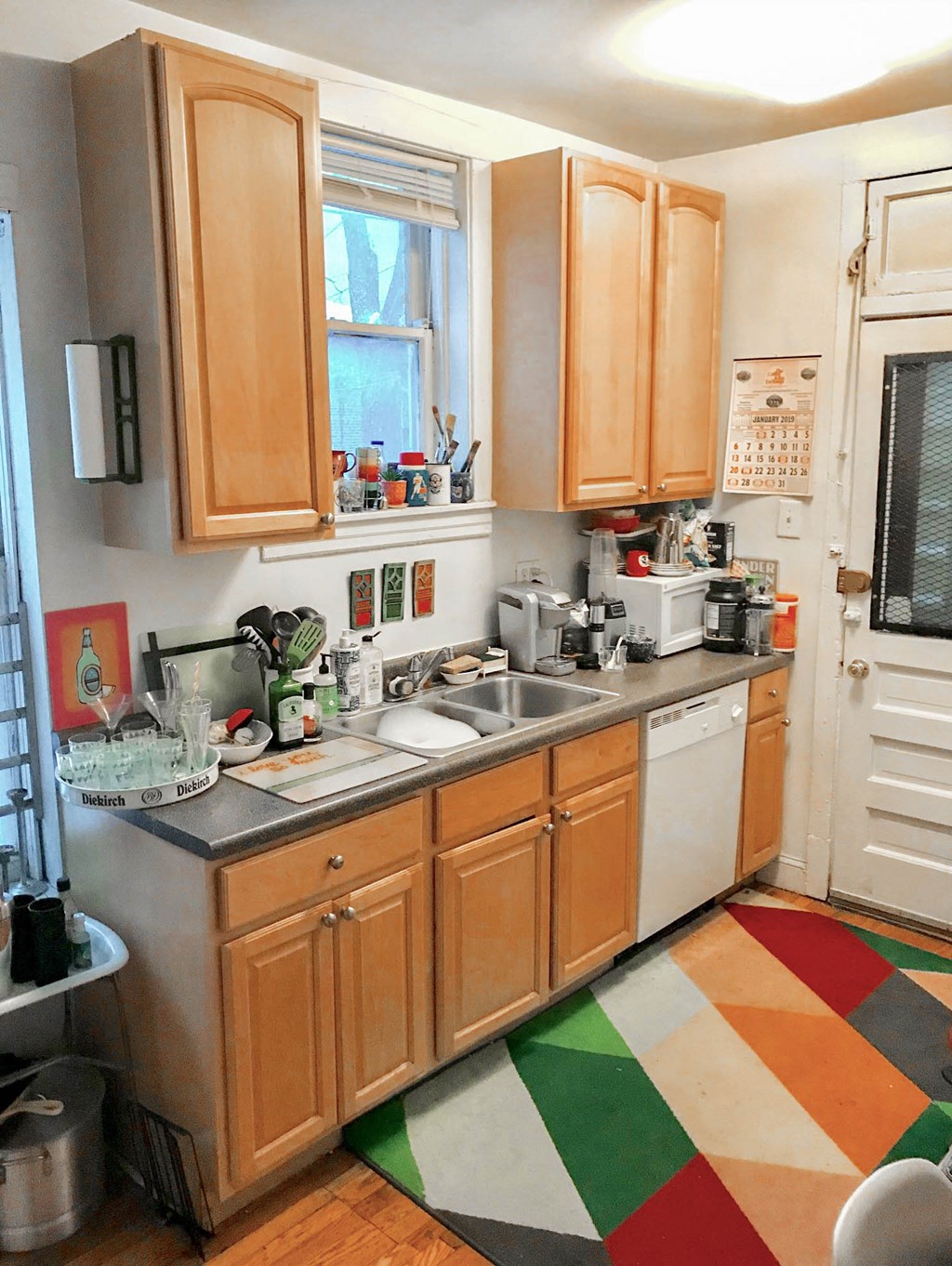 a small kitchen with wooden cabinets and a sink