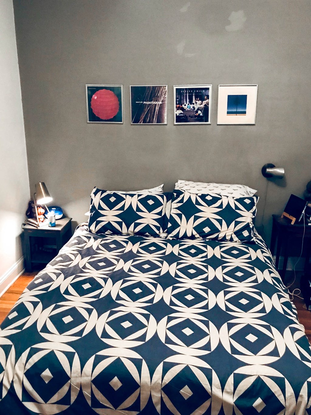 a bedroom with a bed with a blue and white comforter