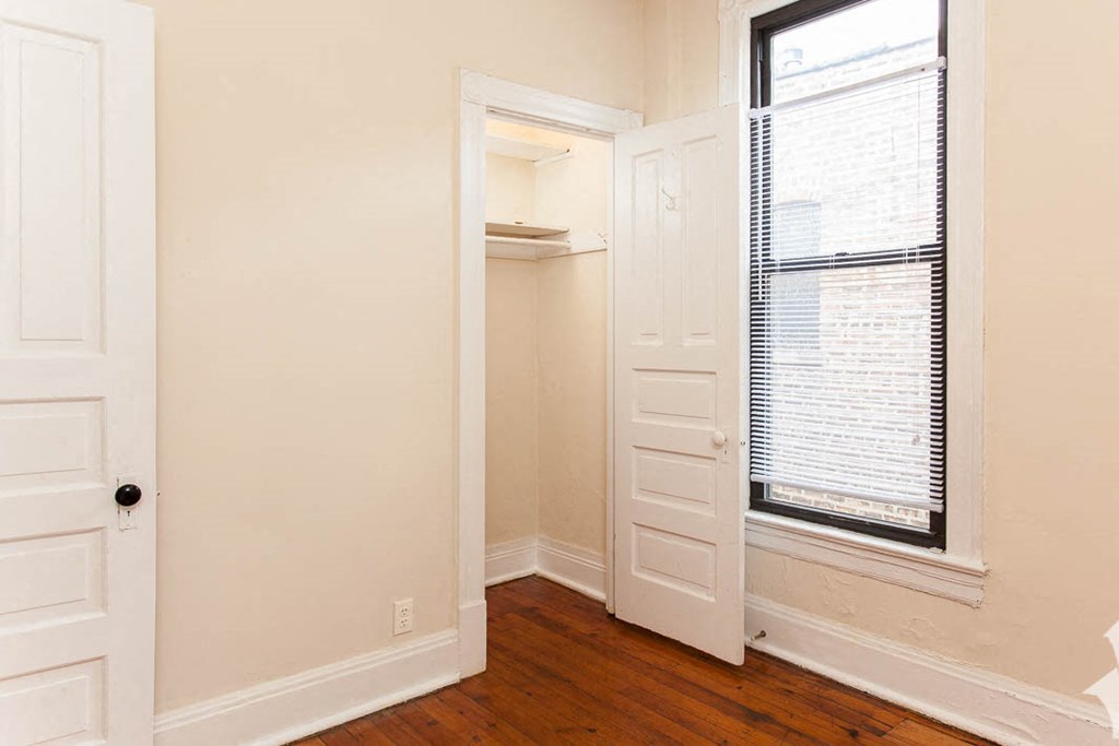 a room with a closet and a window and a door