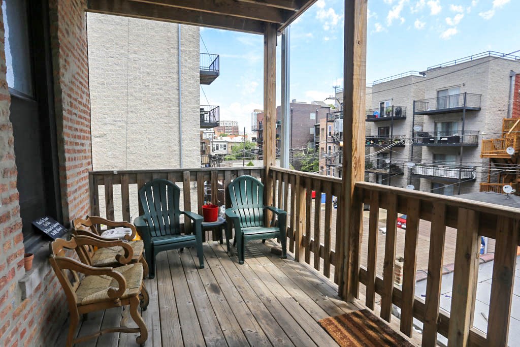 a deck with chairs and a view of the city