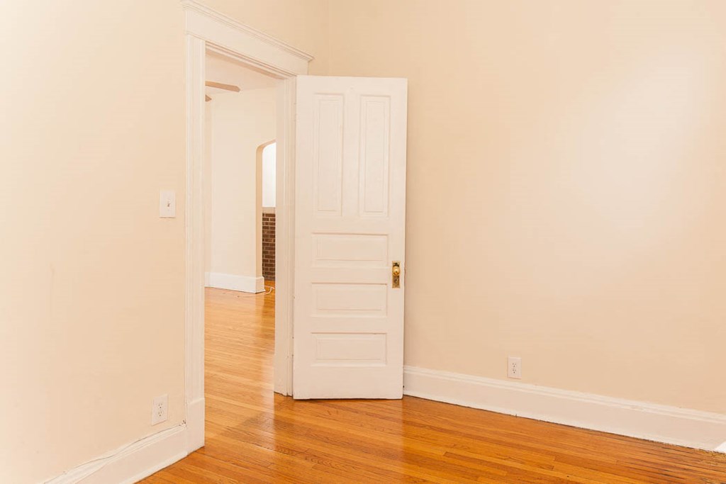 a room with a door and a wood floor